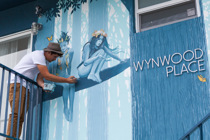 Artist @adrianavilaart painting our front mural