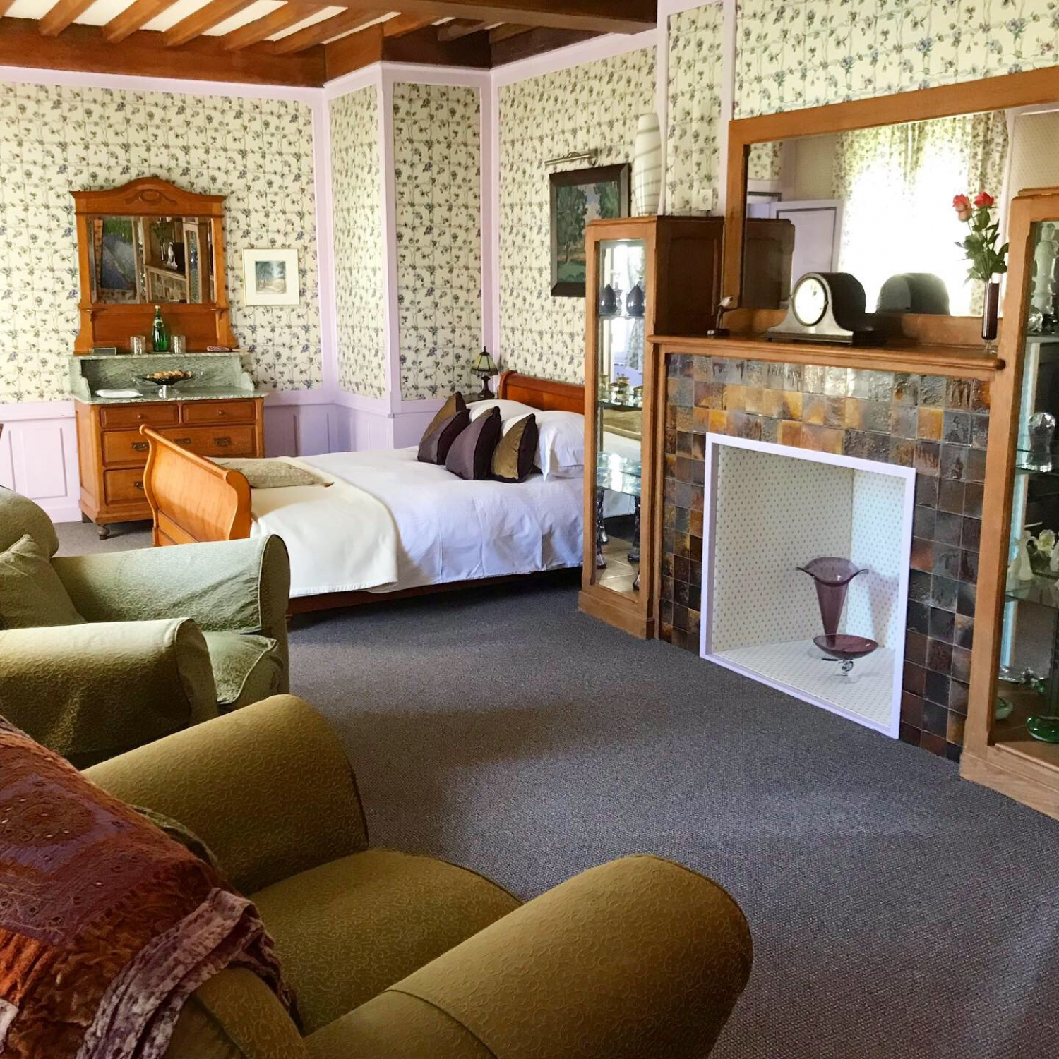 The Junior garden suite has a sleigh bed, large art deco wardrobe, dresser, desk and two large over-stuffed arm chairs