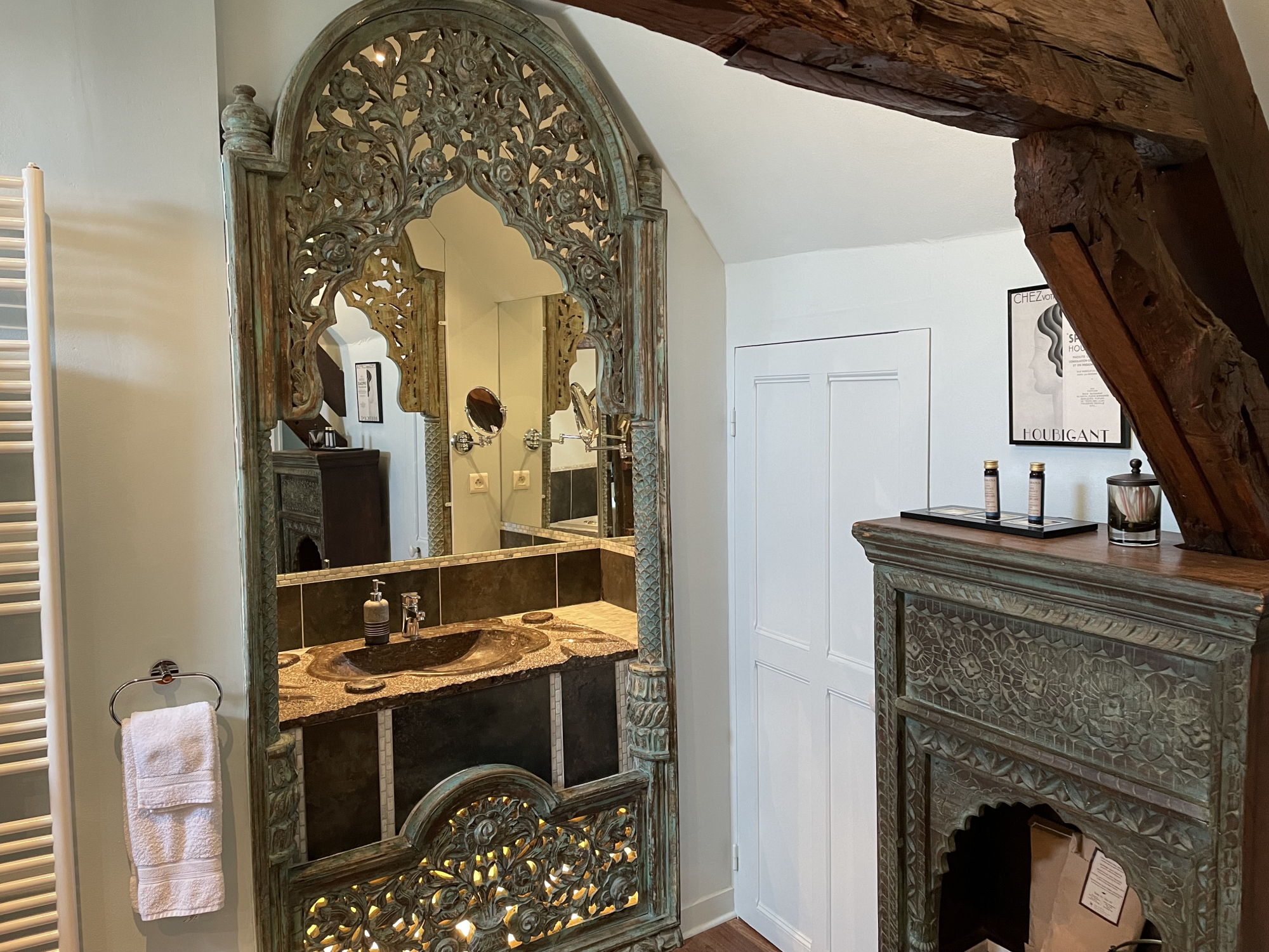 Hand Carved Moorish Cabinets and stone sink are some of the unique features of the Macassar suite