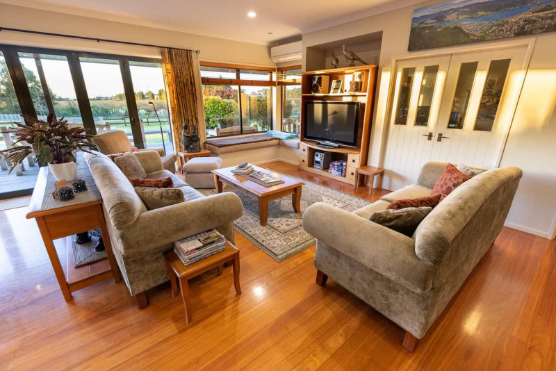 Spacious lounge with sofas and TV